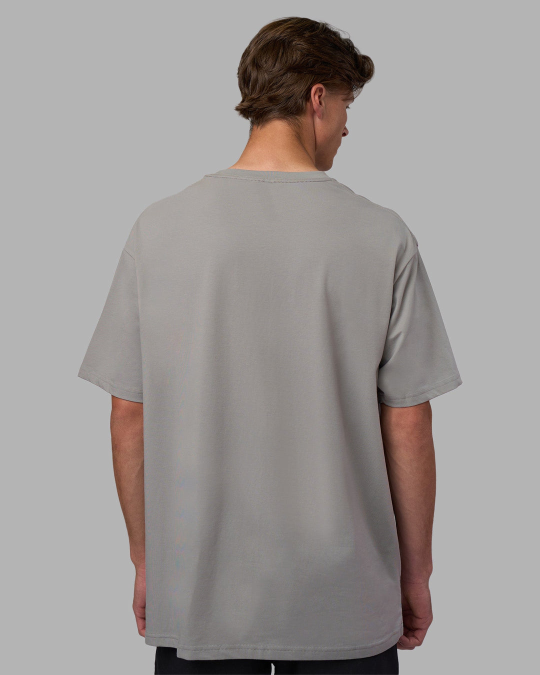 Man wearing Base FLXCotton Tee Oversized - Circular-Grey  Model:Brandon | Size:L