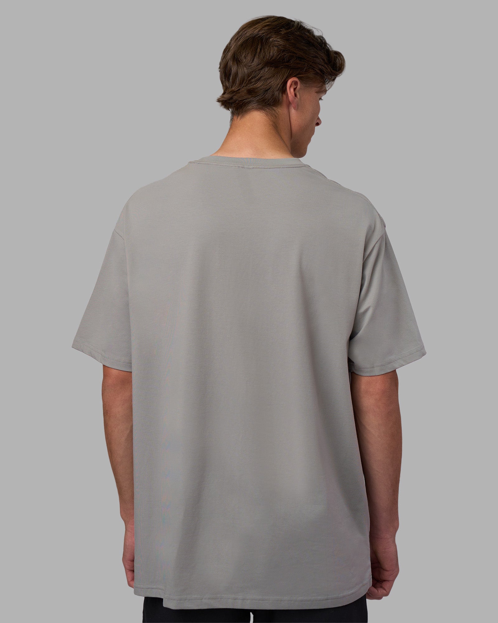 Man wearing Base FLXCotton Tee Oversized - Circular-Grey  Model:Brandon | Size:L