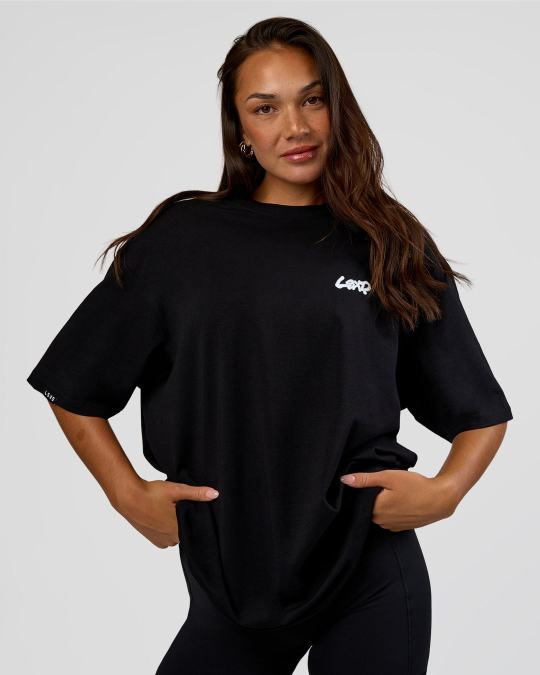Woman wearing Break Through FLXCotton Oversized Tee - Black-Open Air | Model:Kirstyn | Size:L