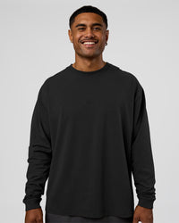 Man wearing Classic Heavyweight FLXCotton Oversized Long Sleeve Tee - Washed Black-Black | Model:Xav | Size:L