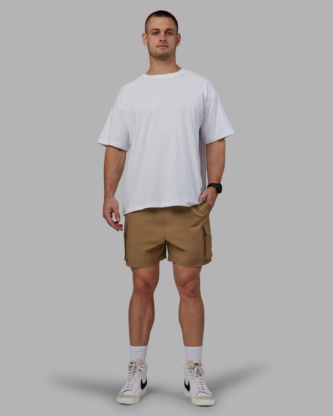 Man wearing Energy Stretch Performance Cargo Shorts - Otter