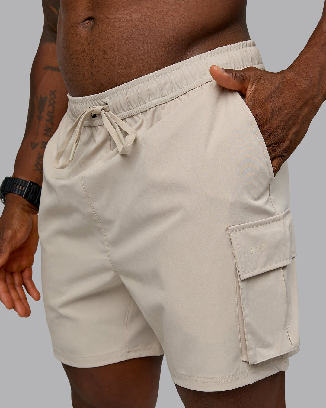 Man wearing Energy Stretch Performance Cargo Short in Shale Beige | Size:L | Model:Sam