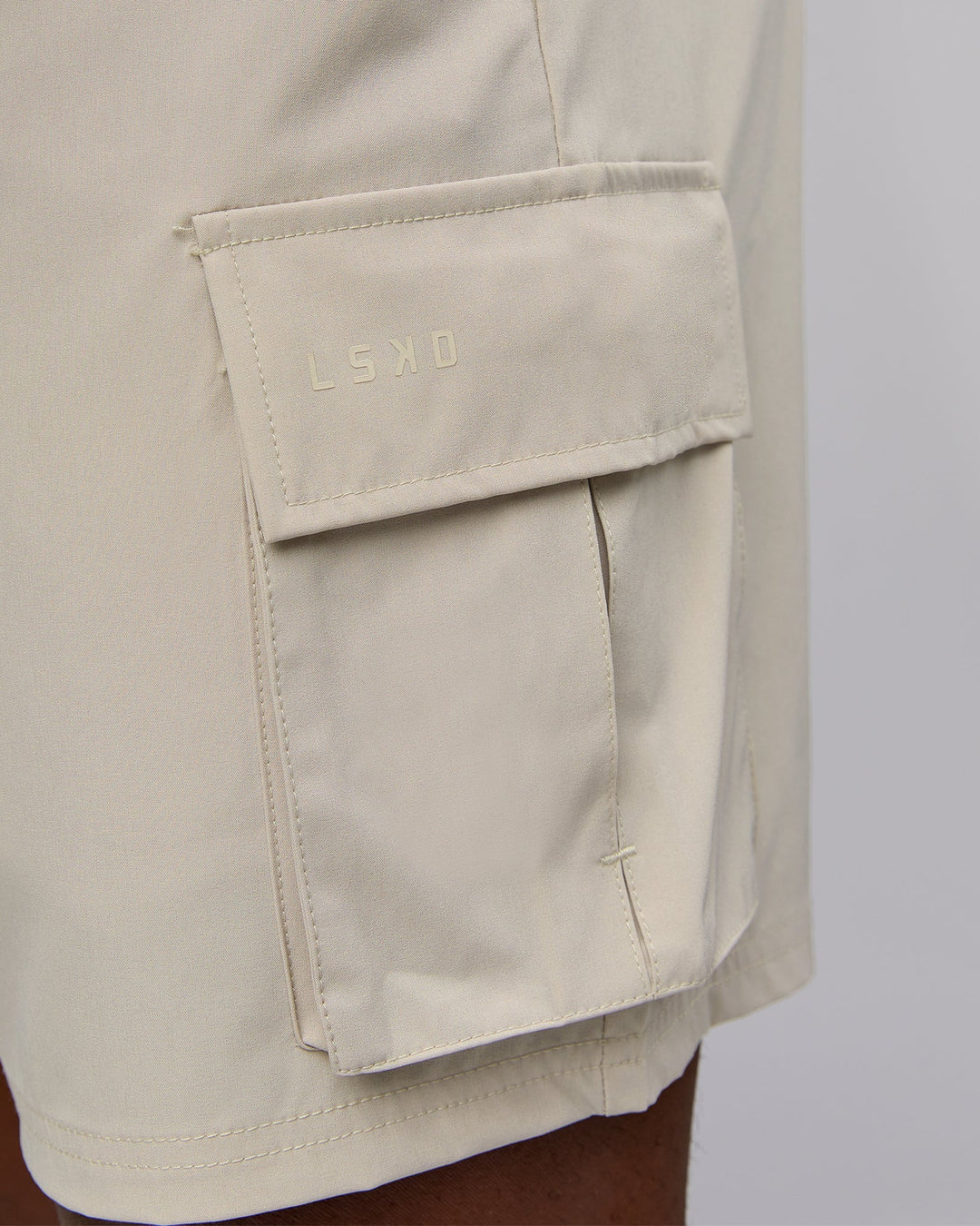 Man wearing Energy Stretch Performance Cargo Short in Shale Beige | Size:L | Model:Sam