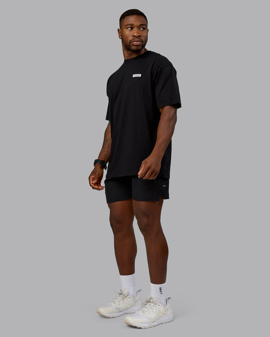 Man wearing Fitstop Embrace the Sweat FLXCotton Oversized Tee in Black-White | Size:L