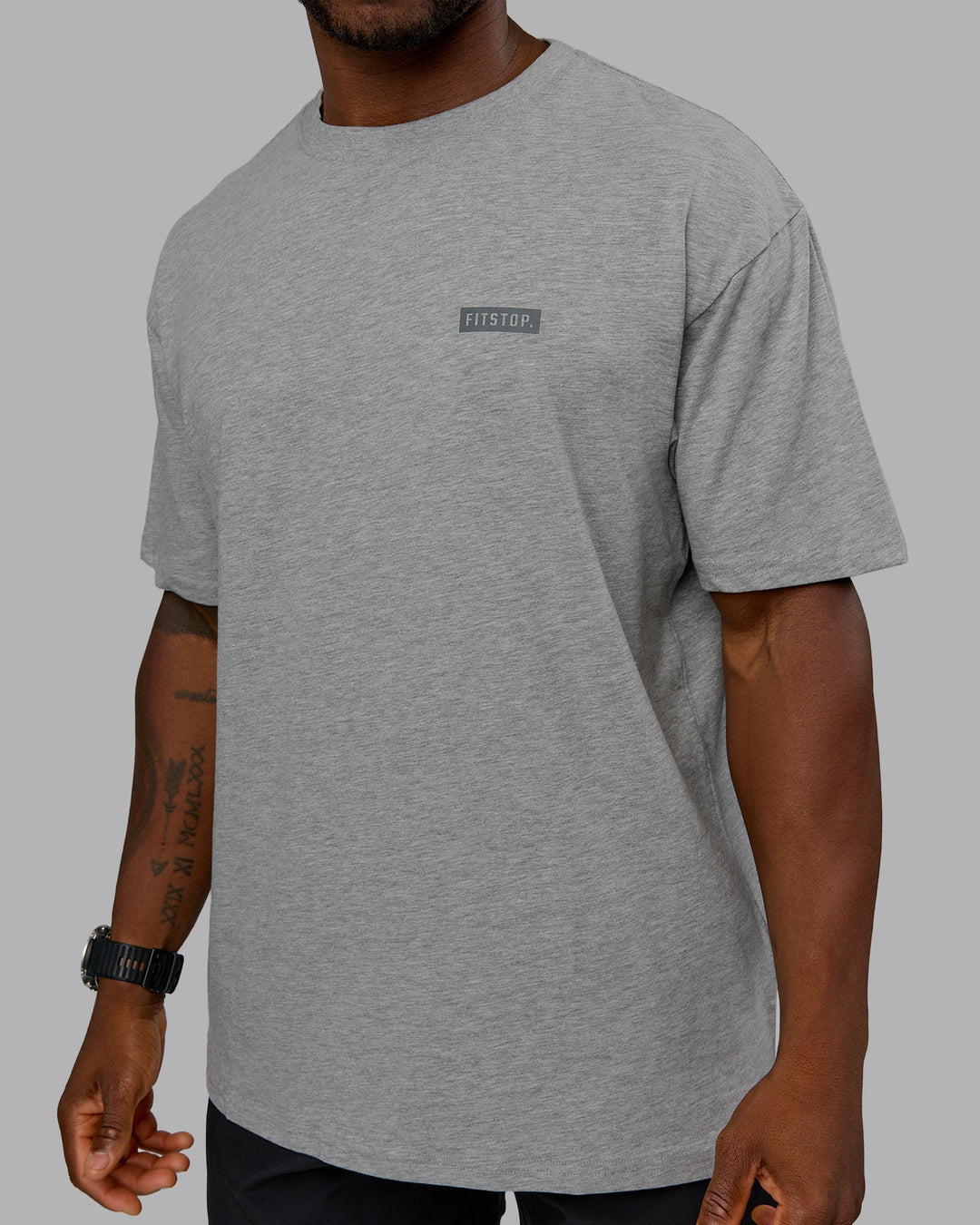 Man wearing Fitstop Embrace the Sweat FLXCotton Oversized Tee in Light Grey Marl-Cool Grey | Size:L