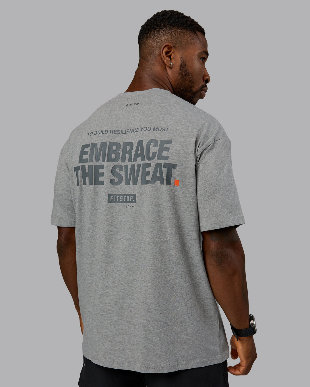 Man wearing Fitstop Embrace the Sweat FLXCotton Oversized Tee in Light Grey Marl-Cool Grey | Size:L