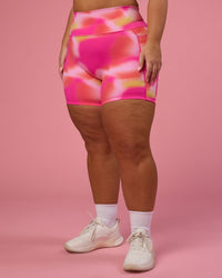 Woman wearing Fusion Ultra High-Rise 6" Short Pockets - Pink Glow Print | Model:Bianca | Size:L