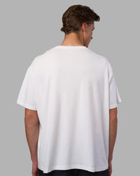 Man wearing Go-To FLXCotton Oversized Tee - White-Black | Model:Brandon | Size:L