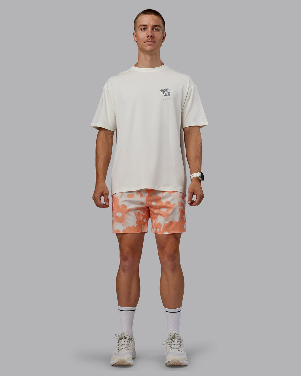 Man wearing Grand Slam 6" Shorts in Wildflower Cantaloupe | Size:L