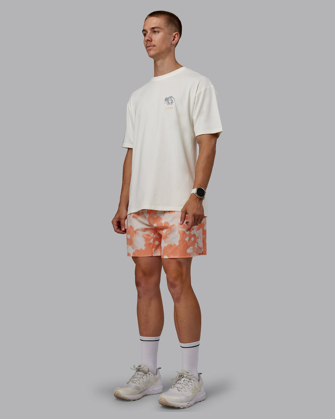 Man wearing Grand Slam 6&quot; Shorts in Wildflower Cantaloupe | Size:L