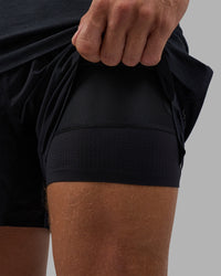 Man wearing Hybrid Lined 5" Short - Black-Reflective | Model:Nikola | Size:L