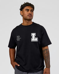 Man wearing Hype Heavyweight Unisex Oversized Tee - Black-White | Model:Xavier | Size:L