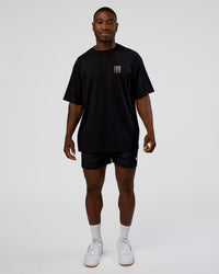 Man wearing Inferno Journey FLXCotton Oversized Tee - Black-Ultra Fuchsia | Model:Sam | Size:L