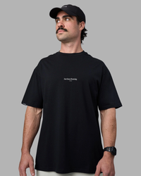 Man wearing Just Keep Running FLXCotton Oversized Tee - Black | Model:Adam | Size:L