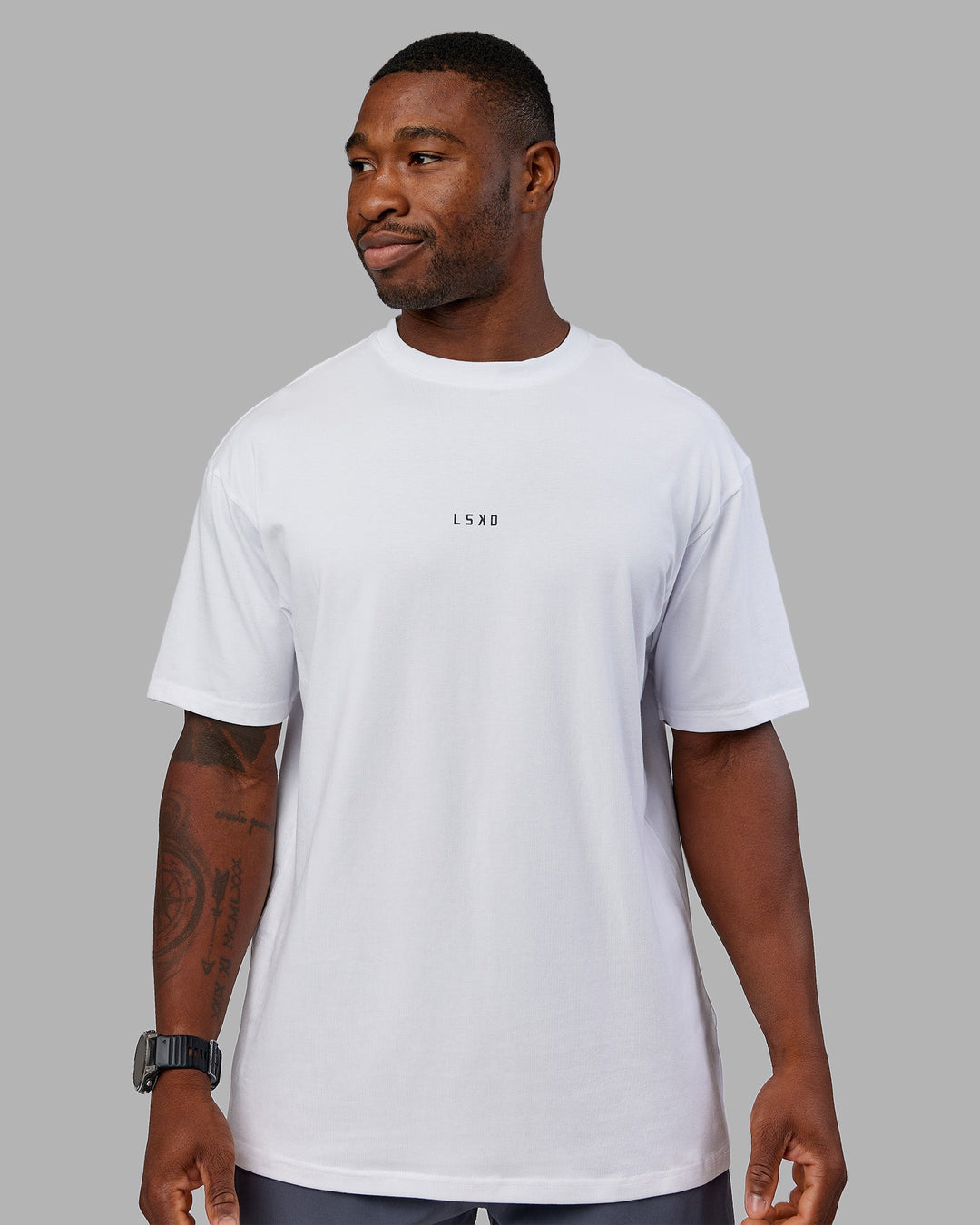 Man wearing Kettlebell FLXCotton Oversized Tee - White-Black | Model:Sam | Size:L