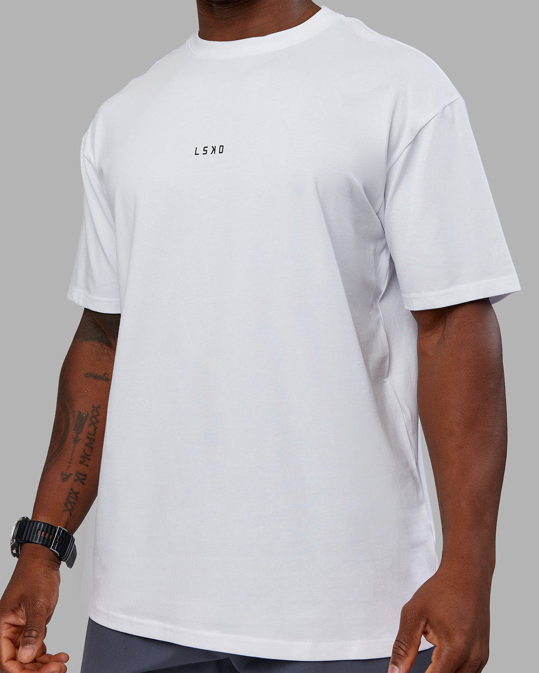 Man wearing Kettlebell FLXCotton Oversized Tee - White-Black | Model:Sam | Size:L