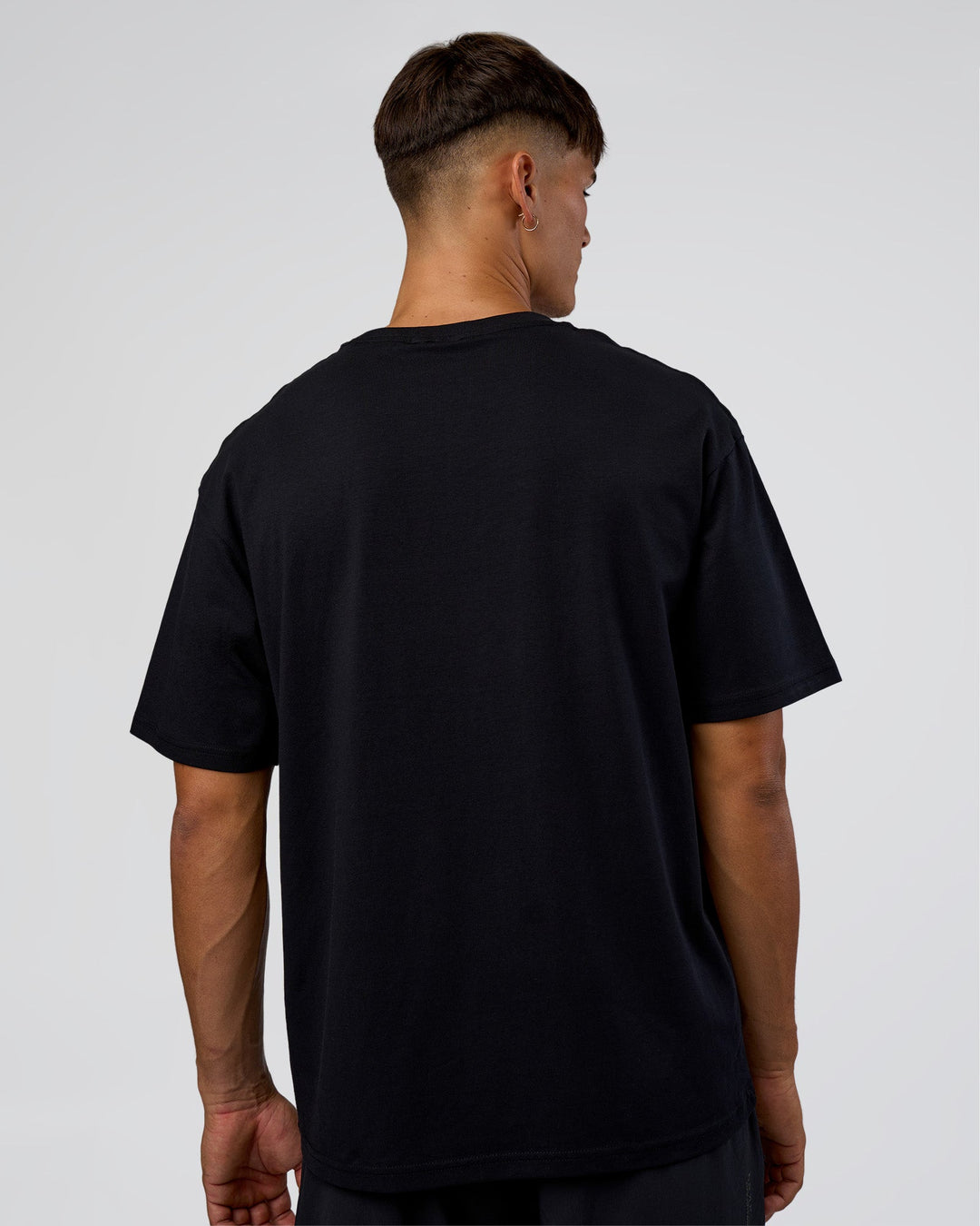 Man wearing LSKD Run Club FLXCotton Oversized Tee - Black-White | Model:Jackson | Size:L