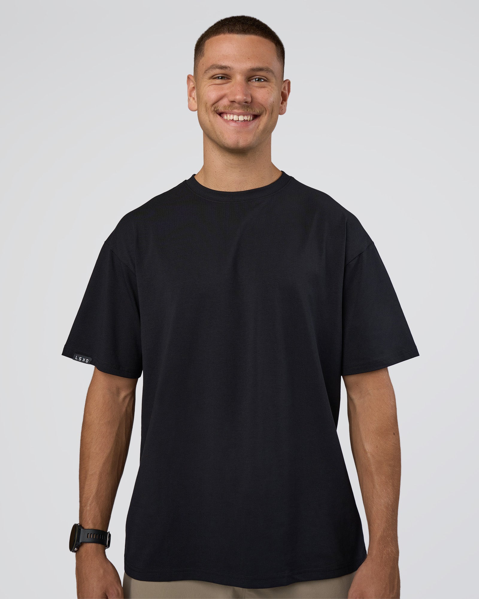 Man wearing Lifting Club FLXCotton Tee Oversize - Black-Black | Model:Nikola | Size:L