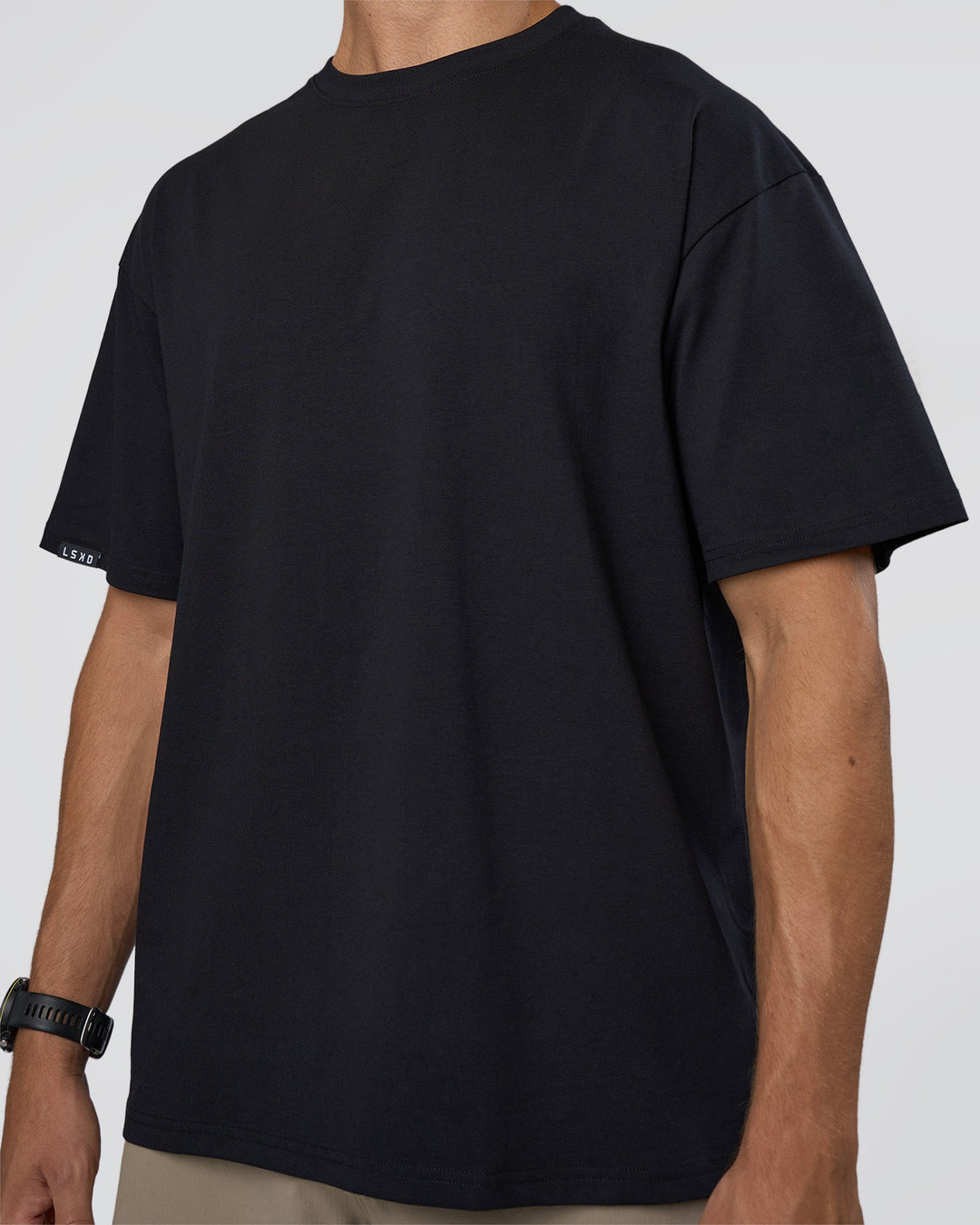 Man wearing Lifting Club FLXCotton Tee Oversize - Black-Black | Model:Nikola | Size:L