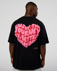 Man wearing Love the Journey FLXCotton Oversized Tee - Black-Flame | Model:Sam | Size:L