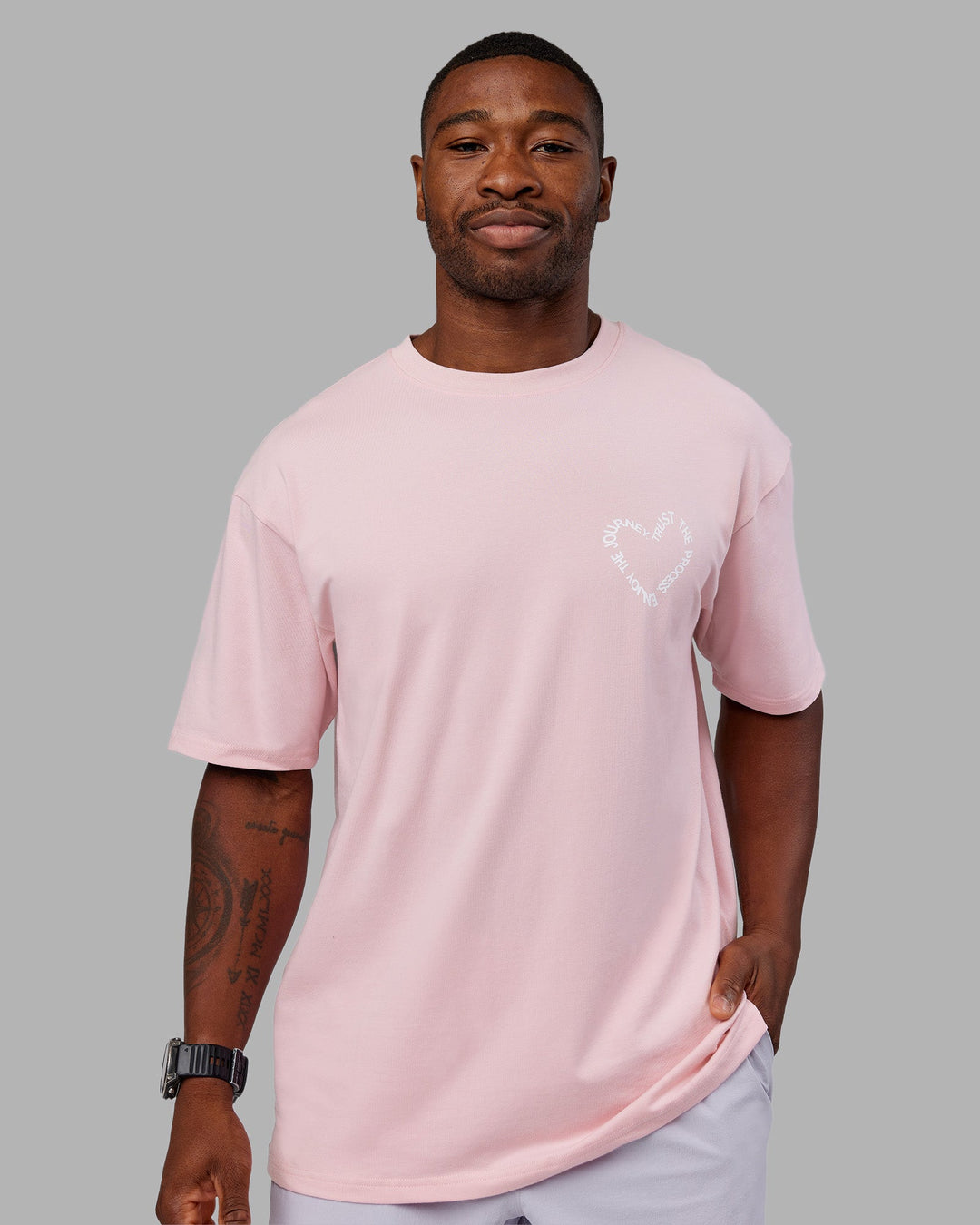 Man wearing Love The Process FLXCotton Oversize Tee - Petal Pink-White | Model:Sam | Size:L