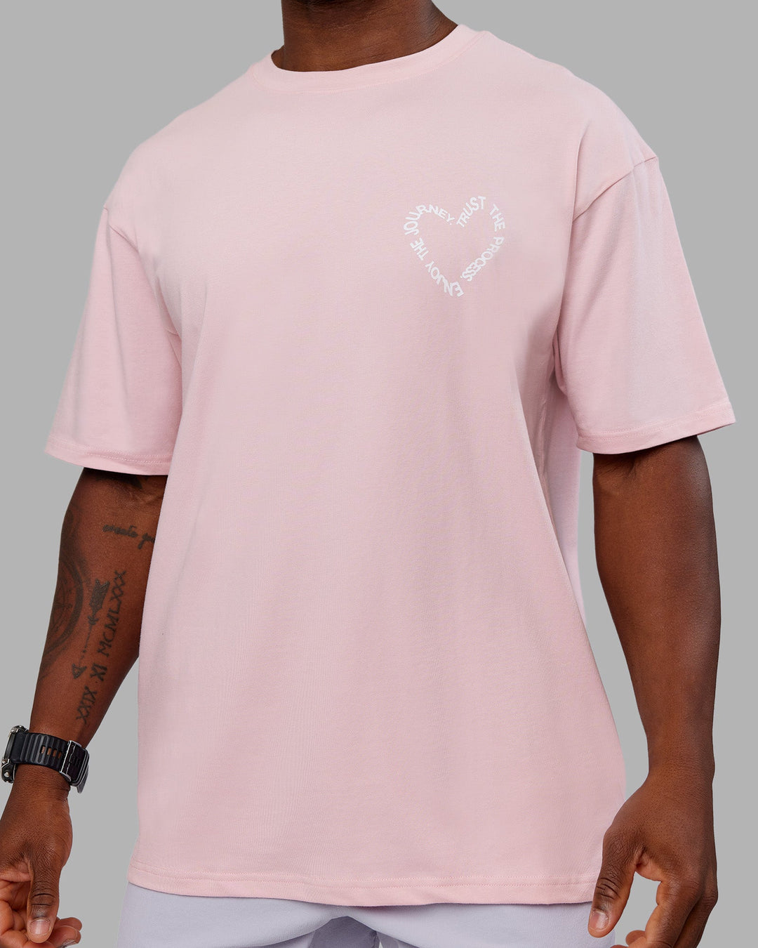 Man wearing Love The Process FLXCotton Oversize Tee - Petal Pink-White | Model:Sam | Size:L