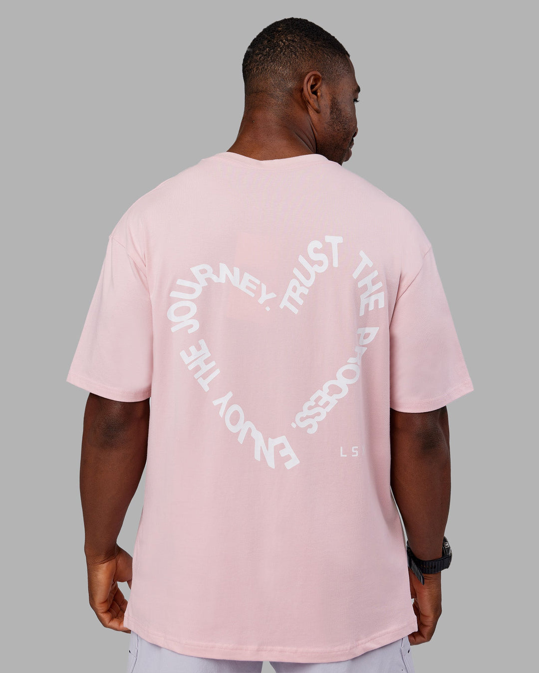 Man wearing Love The Process FLXCotton Oversize Tee - Petal Pink-White | Model:Sam | Size:L