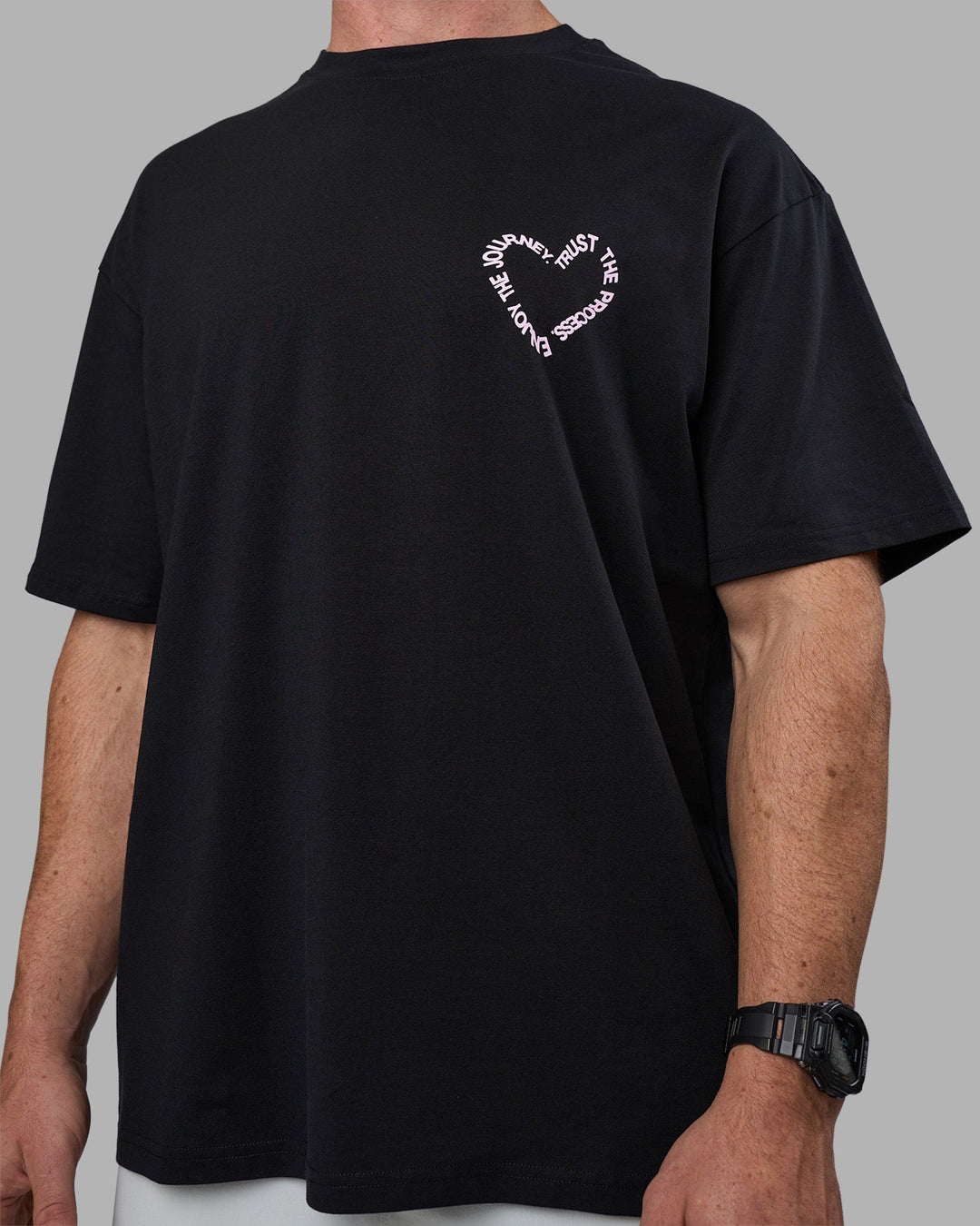 Man wearing Love The Process FLXCotton Oversize Tee - Black-Bubblegum | Model:Adam | Size:L