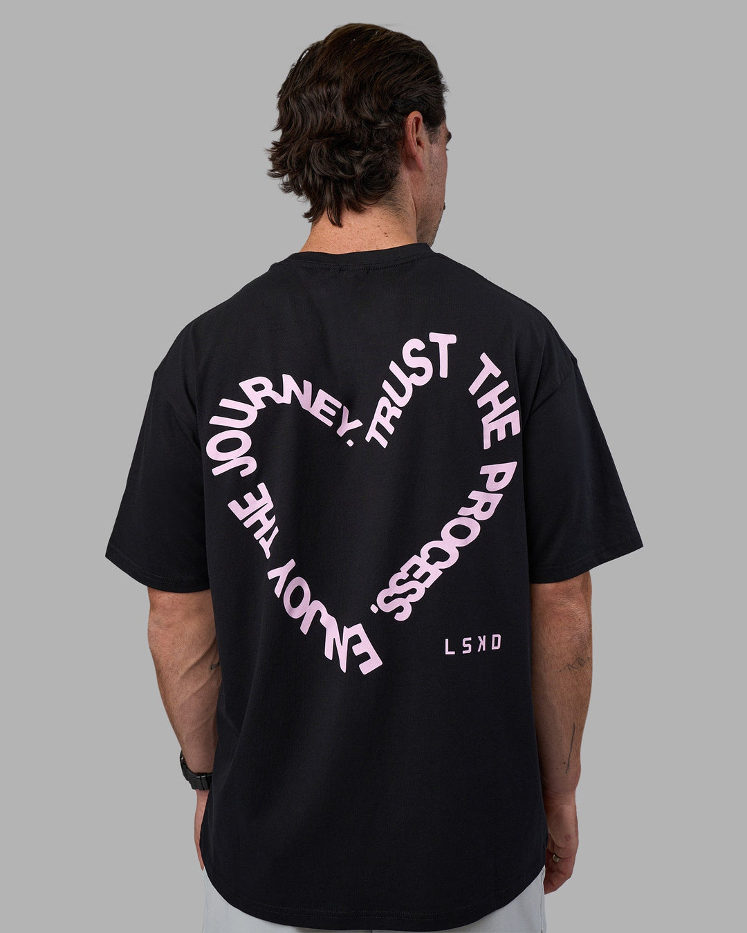 Man wearing Love The Process FLXCotton Oversize Tee - Black-Bubblegum | Model:Adam | Size:L