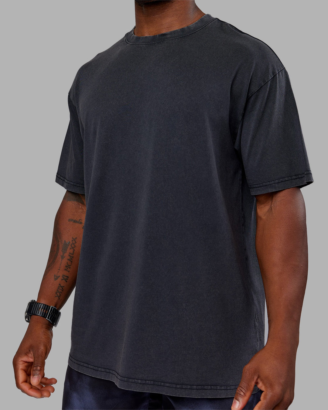 Man wearing Love The Run FLXCotton Tee Oversize - Black Washed-Circular Grey | Model:Sam | Size:L