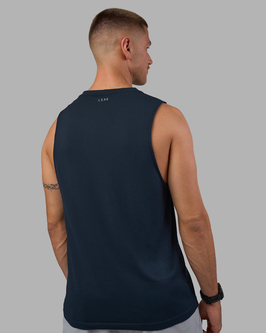 Man wearing AeroFLX+ Seamless Muscle Tank - Navy/Navy | Model:Nikola | Size:L