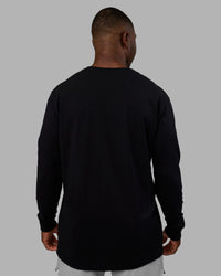 Man wearing Base FLXCotton Long Sleeve Tee - Black | Model:Sam | Size:L