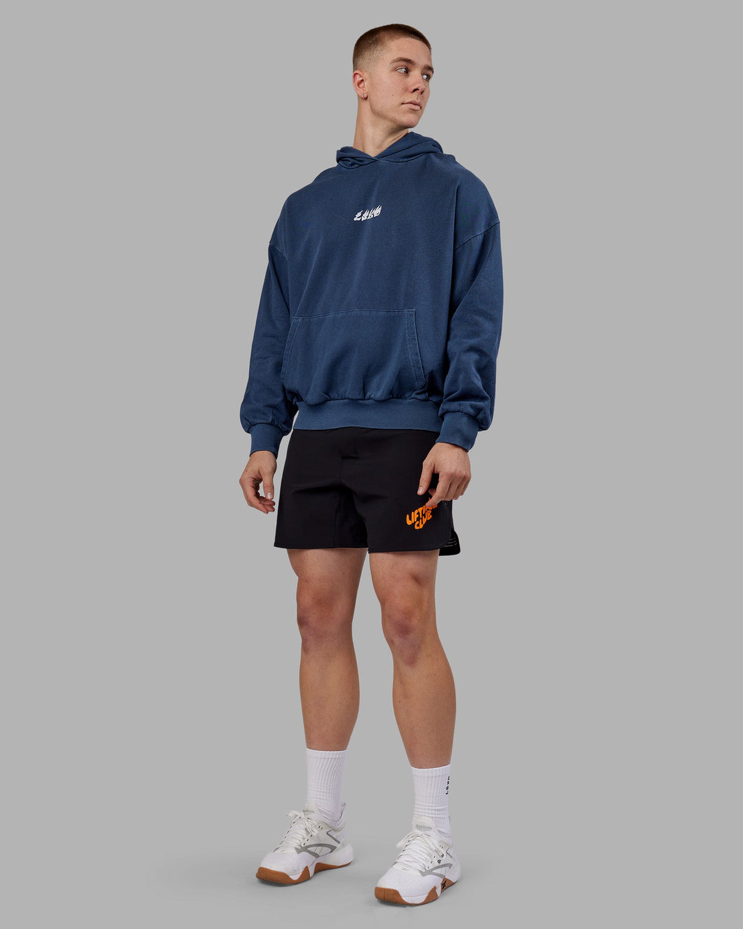 Man wearing NY25 Washed Oversized Hoodie - Future Navy-Ultra Orange | Model:Tom | Size:L