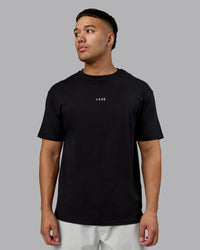 Man wearing On Repeat FLXCotton Oversized Tee - Black-White | Model:Kaelyb | Size:L