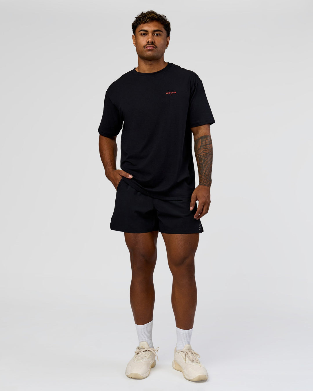 Man wearing RUN CLUB FLXCotton Tee Oversize - Black-Scarlet | Model:Xav | Size:L 