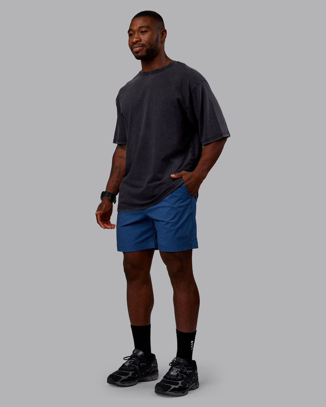 Man wearing Rise &amp; Lift Washed FLXCotton Oversized Tee - Washed Black-Indigo | Model:Sam| Size:L