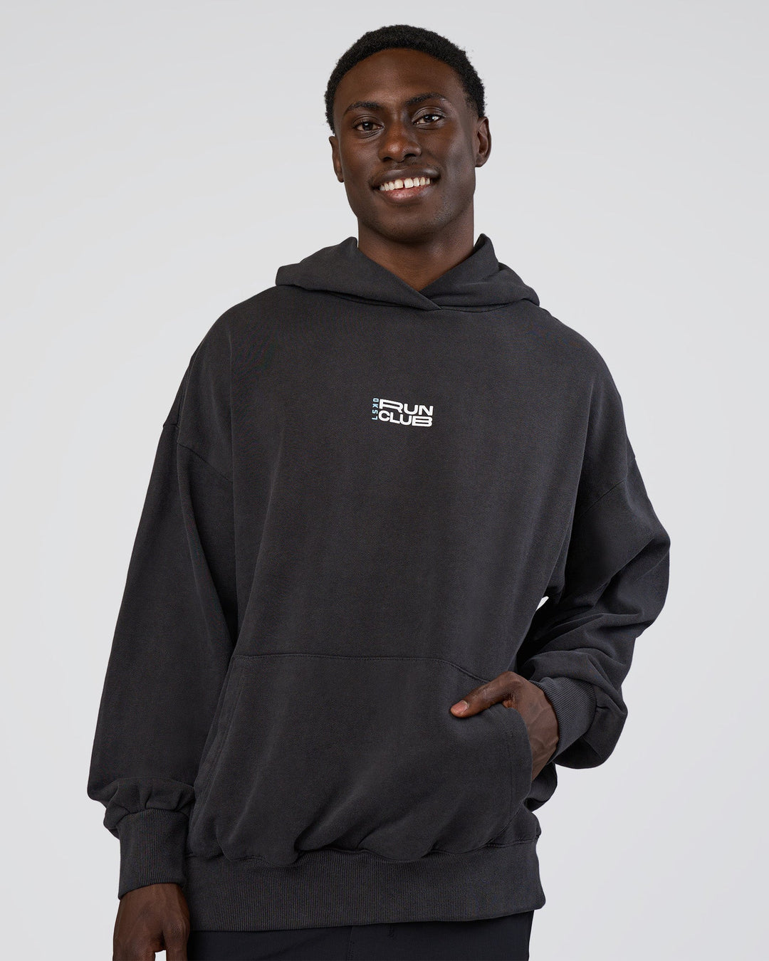 Man wearing Runner’s Unisex Oversized Hoodie - Black Washed-White | Model:Paabio | Size:L
