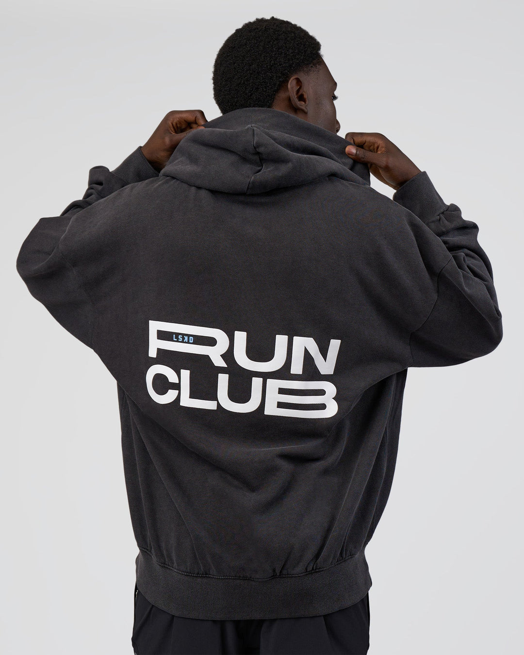 Man wearing Runner’s Unisex Oversized Hoodie - Black Washed-White | Model:Paabio | Size:L