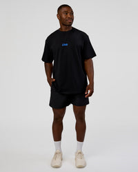 Man wearing Standard Issue FLXCotton Oversized Tee - Black-Palace Blue | Model:Sam | Size:L