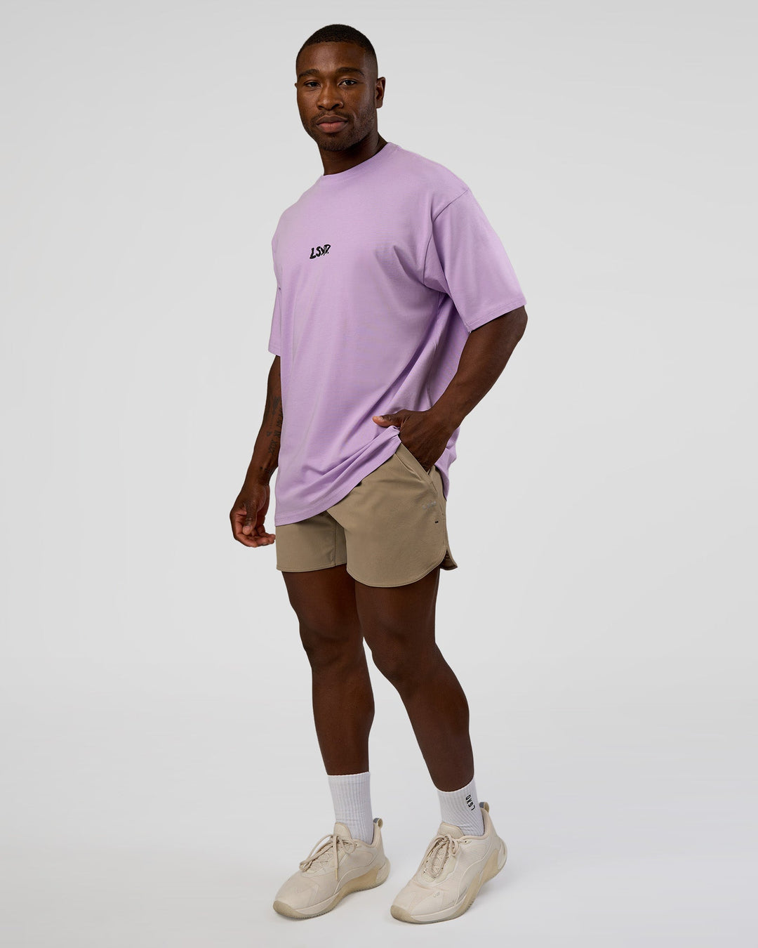Man wearing Standard Issue FLXCotton Oversized Tee - Pale Lilac-Black | Model:Sam | Size:L
