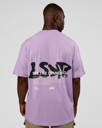 Man wearing Standard Issue FLXCotton Oversized Tee - Pale Lilac-Black | Model:Sam | Size:L