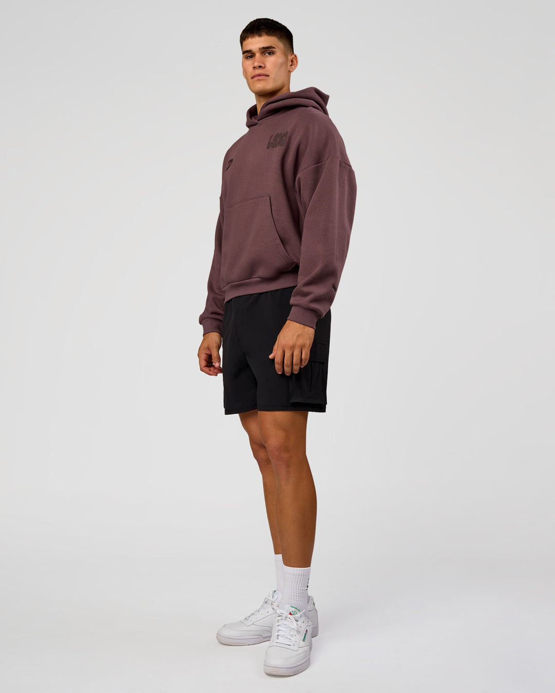 Man wearing Static Grit Unisex Boxy Hoodie - Cocoa Powder-Hot Chocolate | Model:Jackson | Size:L