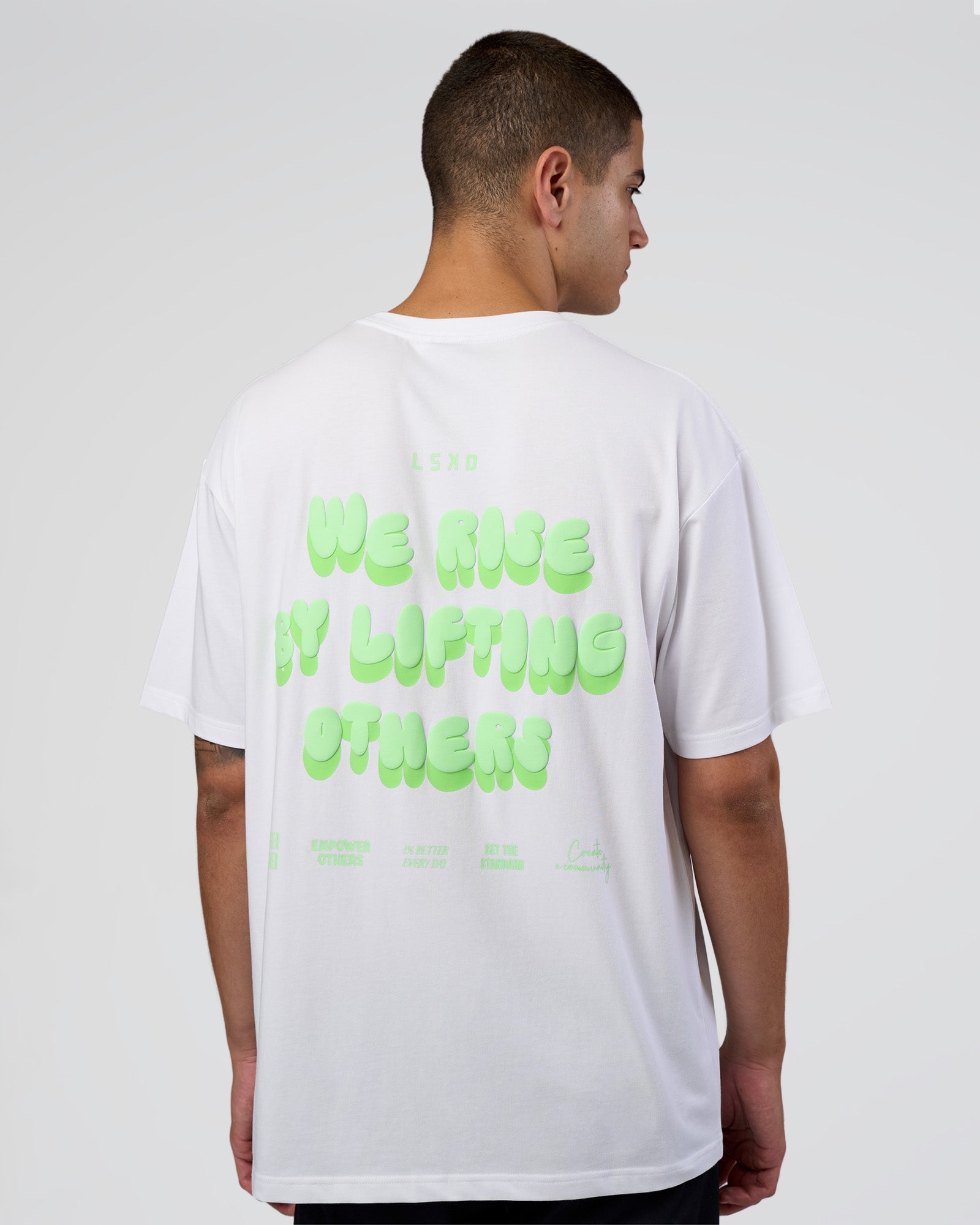 Man wearing Together We Rise FLXCotton Oversized Tee - White-Solar Lime | Model:Zoran | Size:L