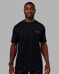 Man wearing Trust The Process 2.0 FLXCotton Tee Oversize - Black-Blue Atoll | Model:Sam | Size:L