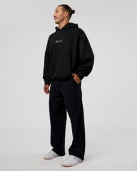 Man wearing Trust The Process Unisex Oversized Hoodie - Black-White | Model:Jaiden | Size:L