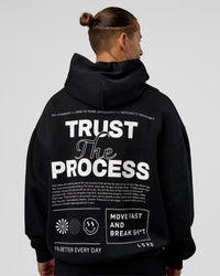 Man wearing Trust The Process Unisex Oversized Hoodie - Black-White | Model:Jaiden | Size:L