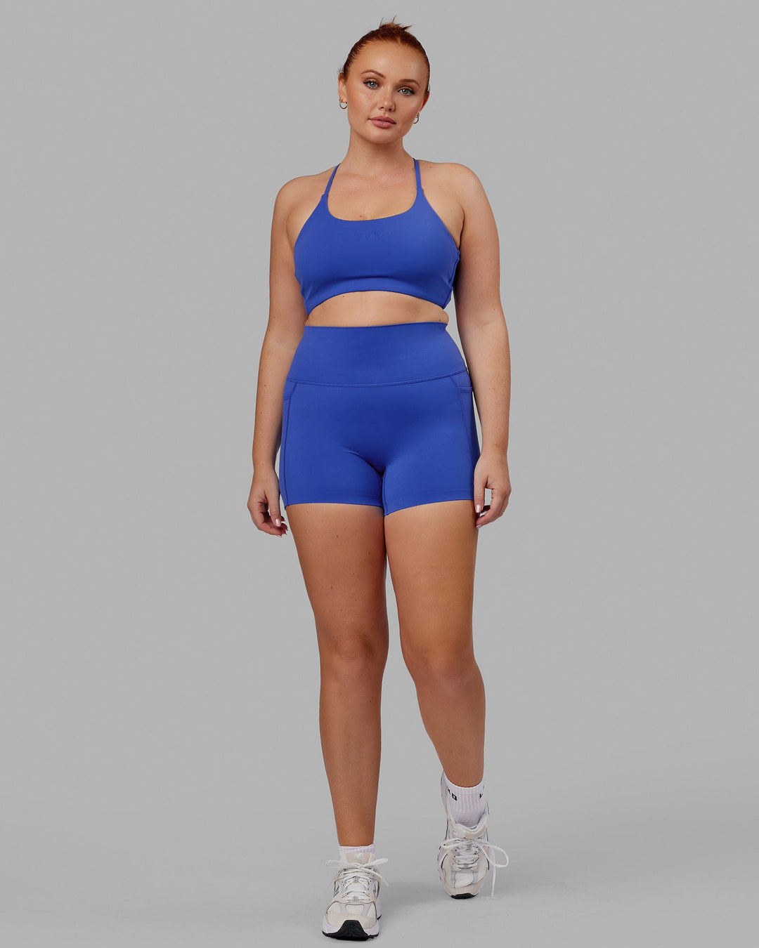 Woman wearing Twist Sports Bra - Power Cobalt