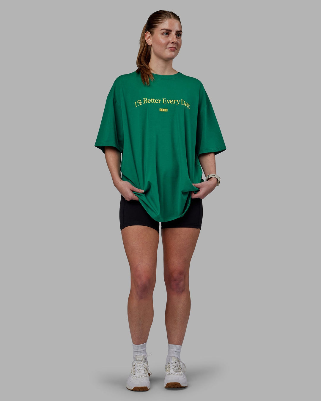 Woman wearing Unisex 1% Better FLXCotton Tee Oversize - Green-Gold