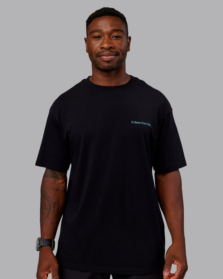 Man wearing Better Every Day FLXCotton Tee Oversize in Black-Blue Atoll | Size:L | Model:Sam
