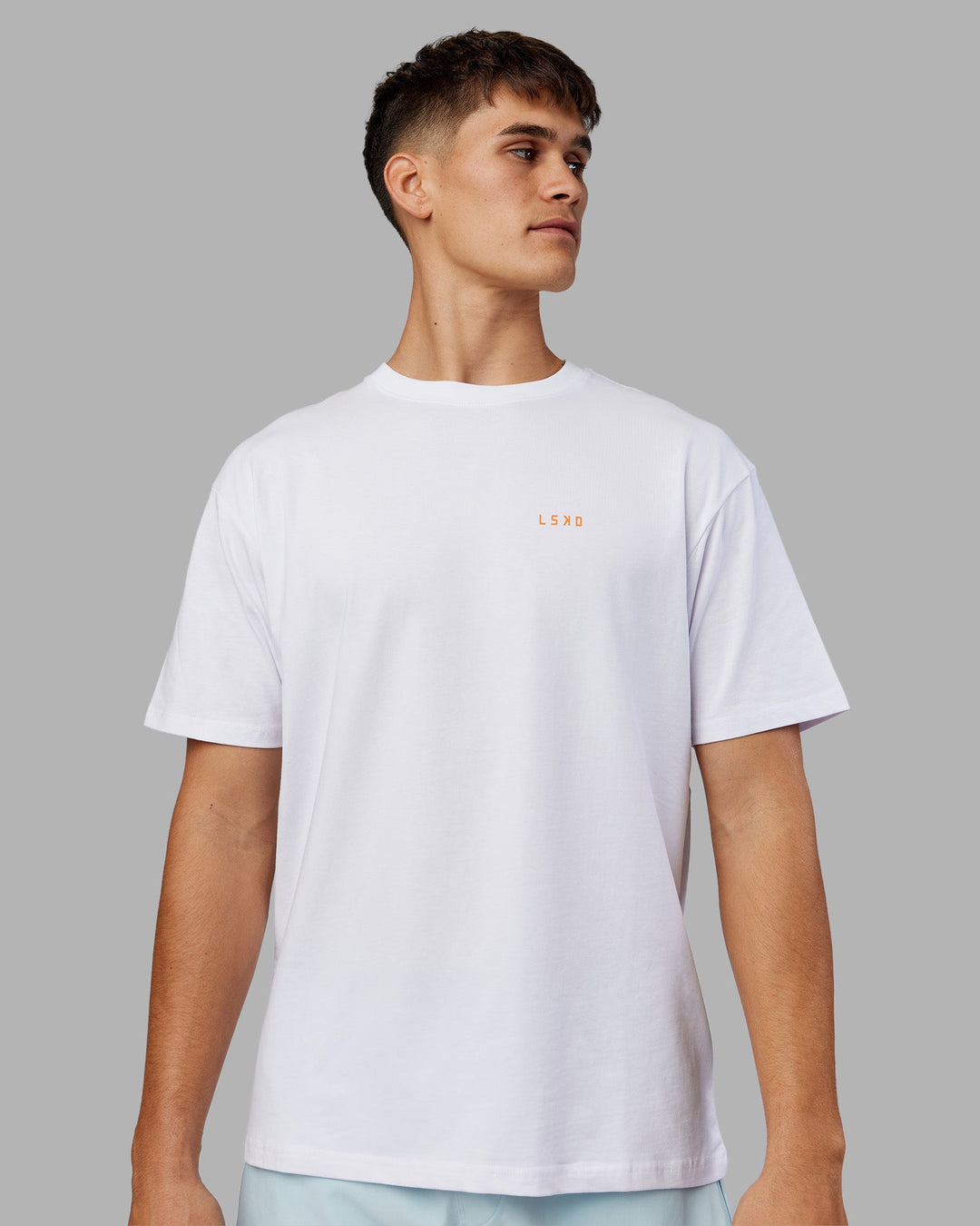Man wearing Enjoy the Journey Value Series FLXCotton Tee Oversize - White-Vibrant Orange | Model:Jackson | Size:L